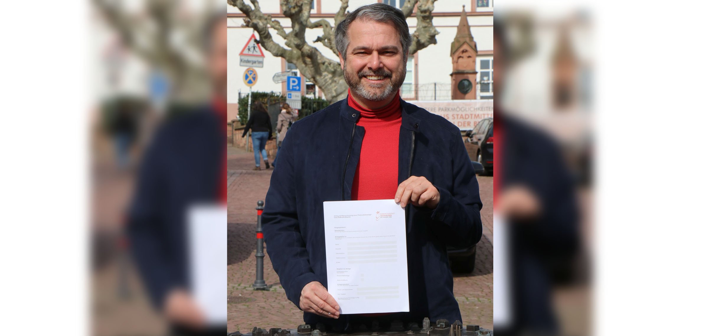 Bürgermeister Glöckner mit dem Antraag auf Förderung von PV-Anlagen am Stadtmodell.