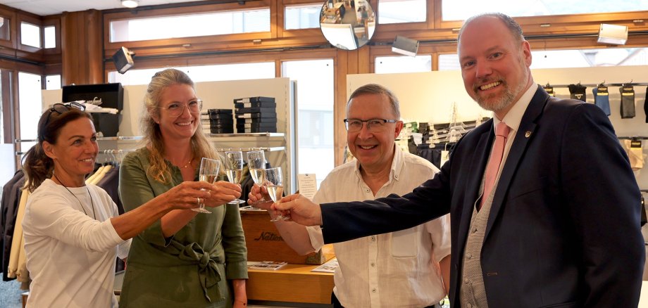 Inhaber und Gäste stoßen mit dem Bürgermeister an. 
