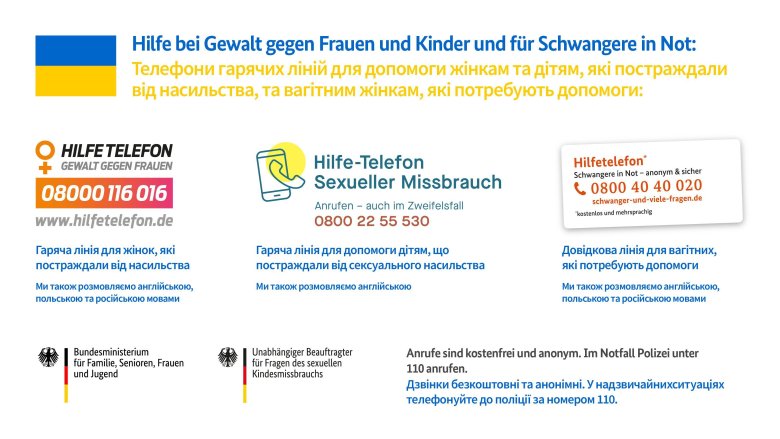 Tafel mit Notruftelefonnummern für Frauen in deutscher und ukrainischer Sprache.