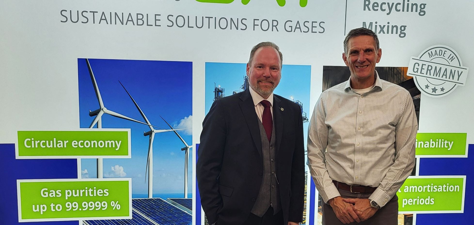 Gelnhausens Bürgermeister Christian Litzinger steht neben ReiCat-Geschäftsführer Michael Höfling vor einer Informationswand der Firma ReiCat. 