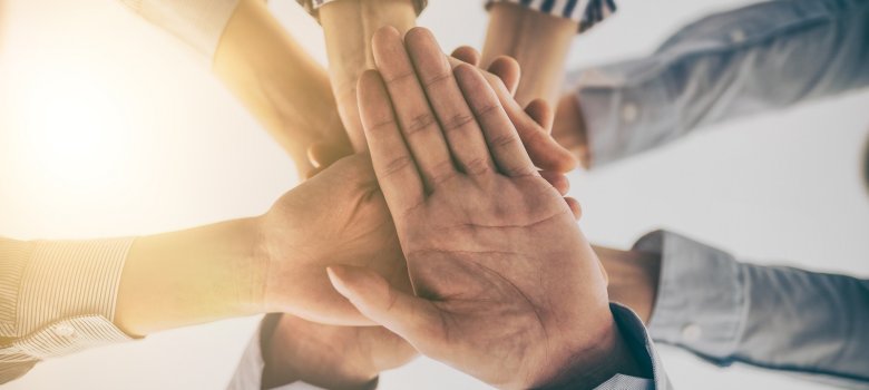 Hands stacked in a pile. A symbol of teamwork and trust.