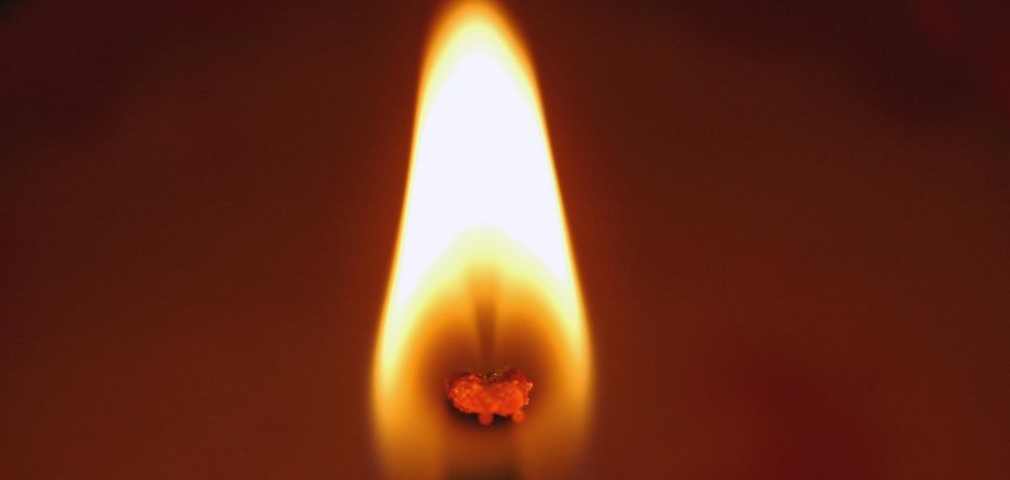 Der brennende Docht einer Kerze.